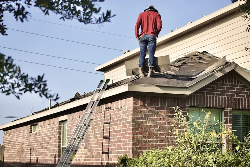Professional roofer working on a residential roof in Wickliffe